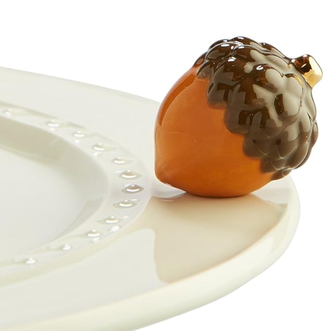 Nora Fleming Acorn Mini on the plate