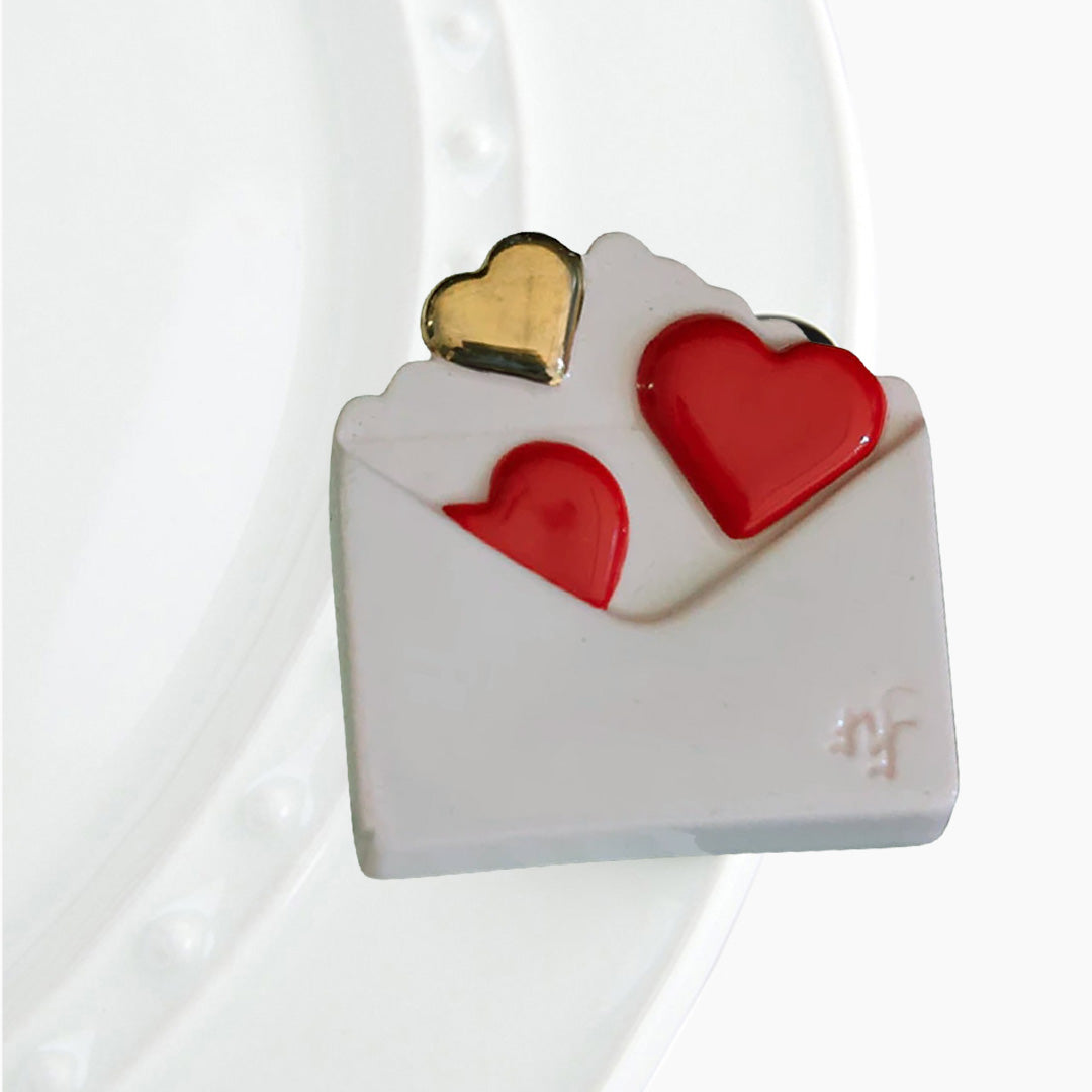 nora fleming valentine envelope on the plate