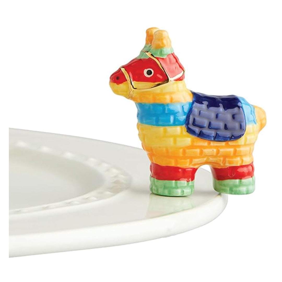 nora fleming pinata on the plate