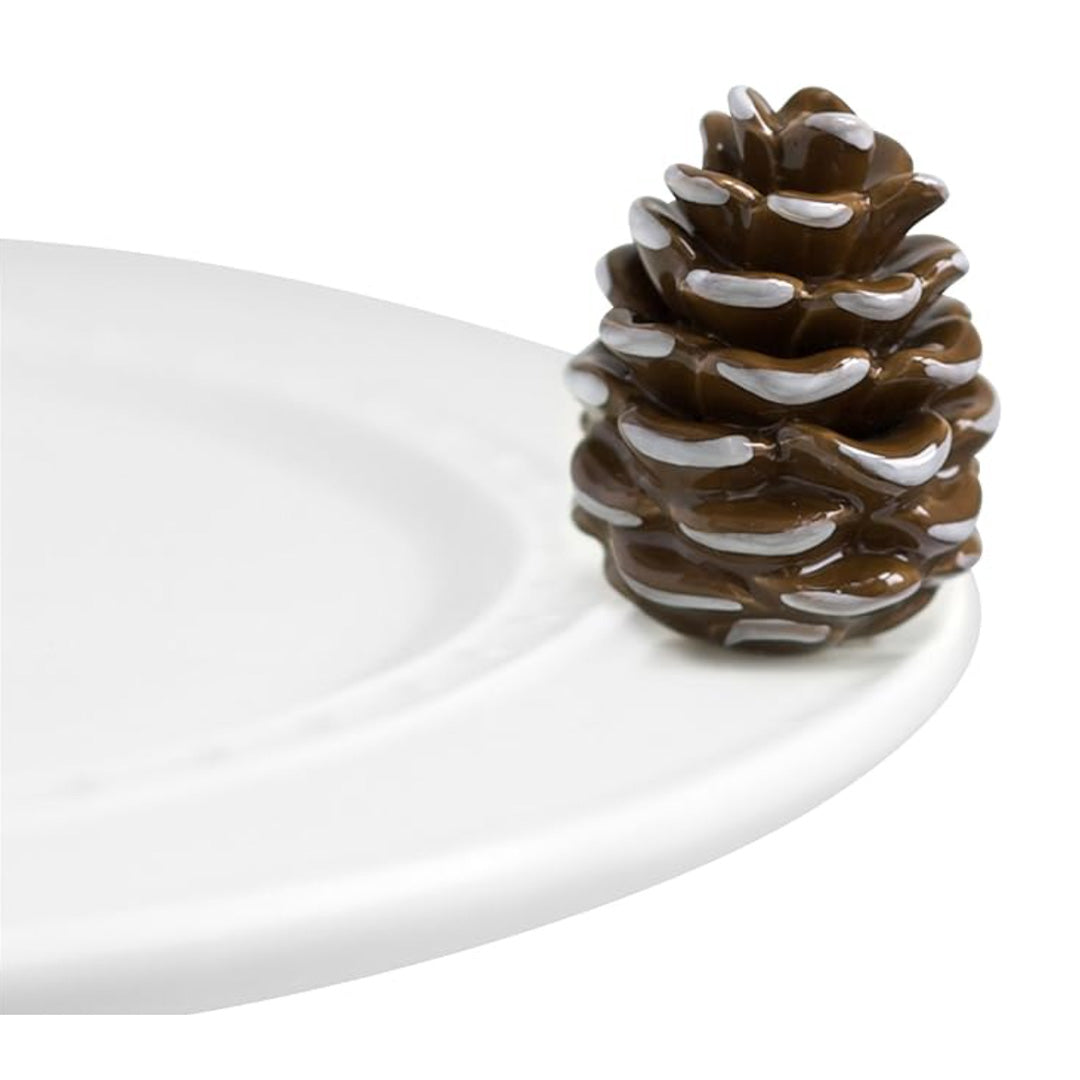 nora fleming pinecone on the plate