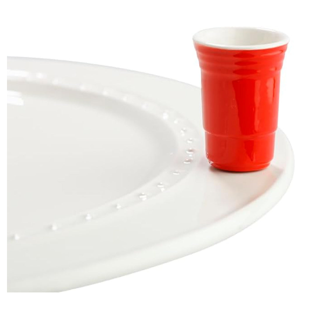 nora fleming red cup on the plate