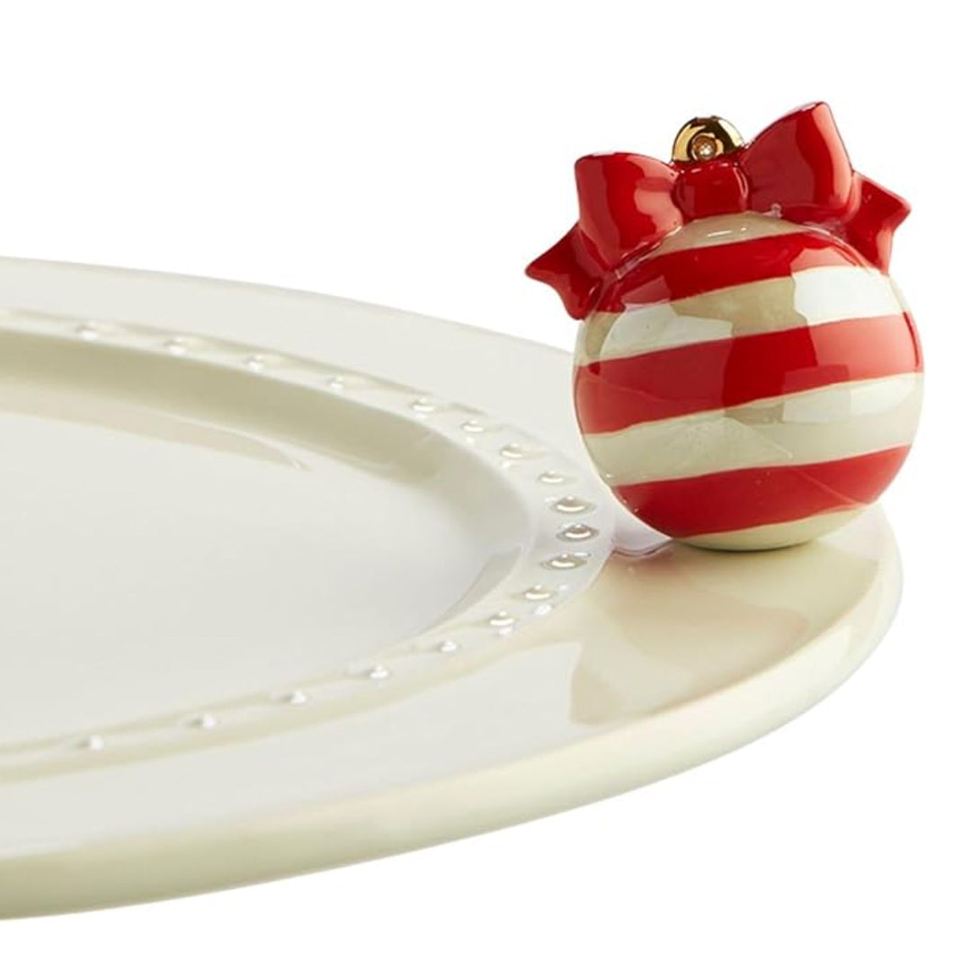 Nora Fleming Red Ornament Mini on the plate