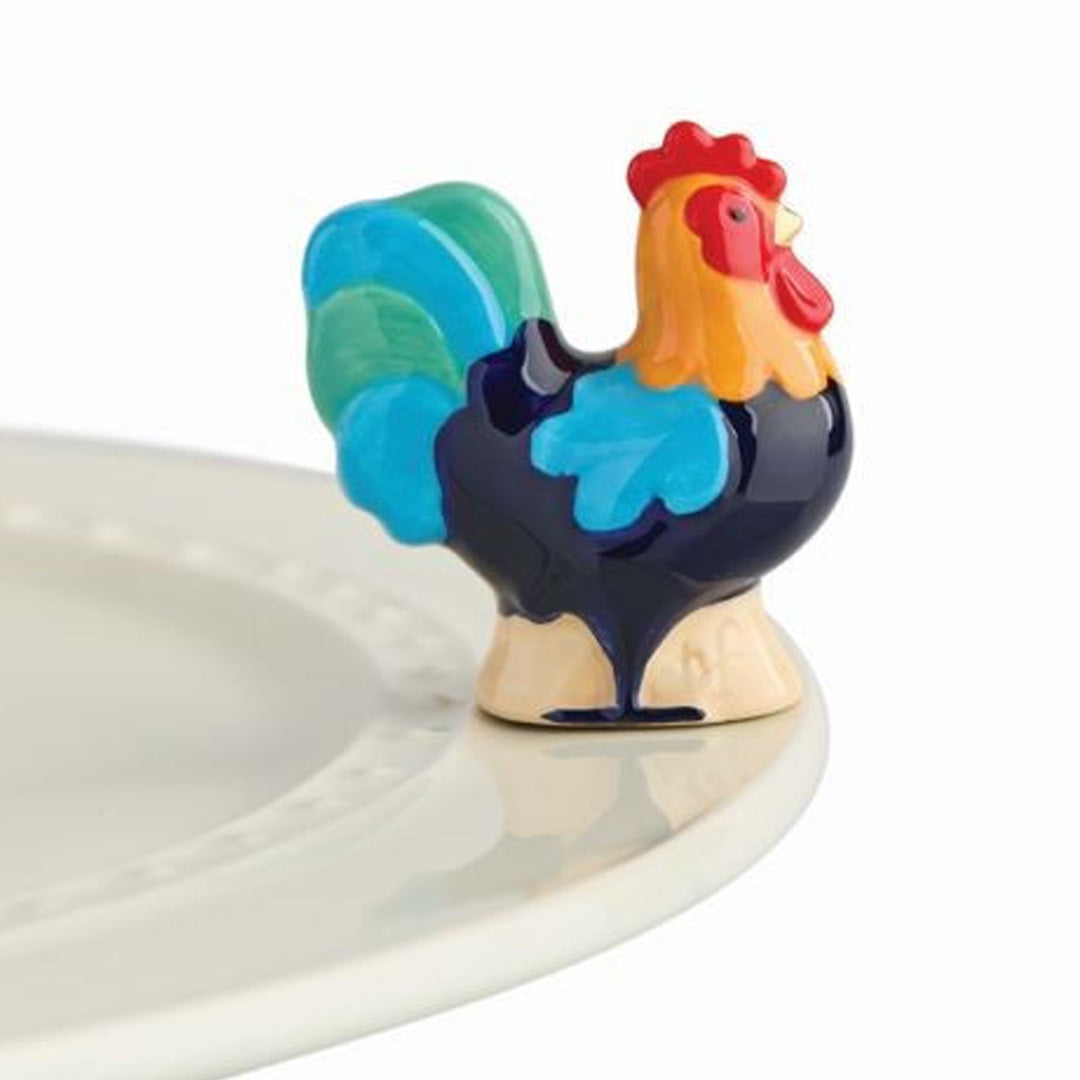 nora fleming rooster on the plate