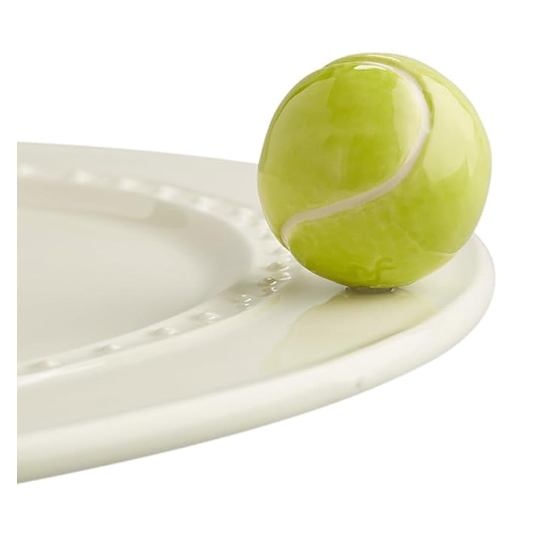 nora fleming tennis ball on the plate