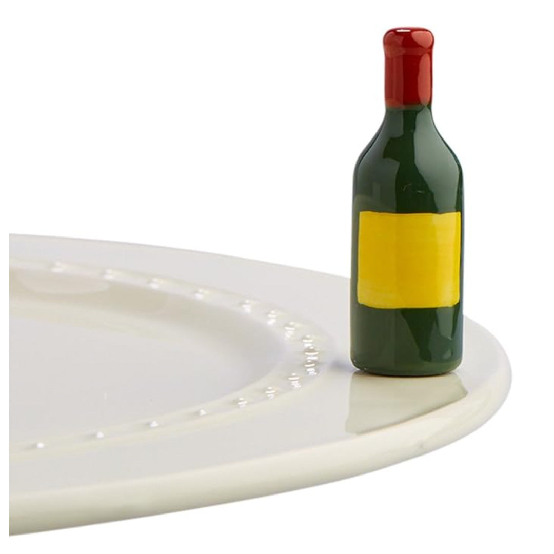 nora fleming wine bottle on the plate
