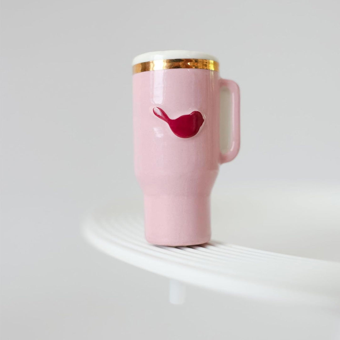 Nora Fleming sip happens Insulated Tumbler on the plate