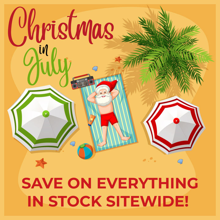 Promotional graphic for 'Christmas in July' sale with Santa Claus on a beach towel, umbrellas, and palm leaves.