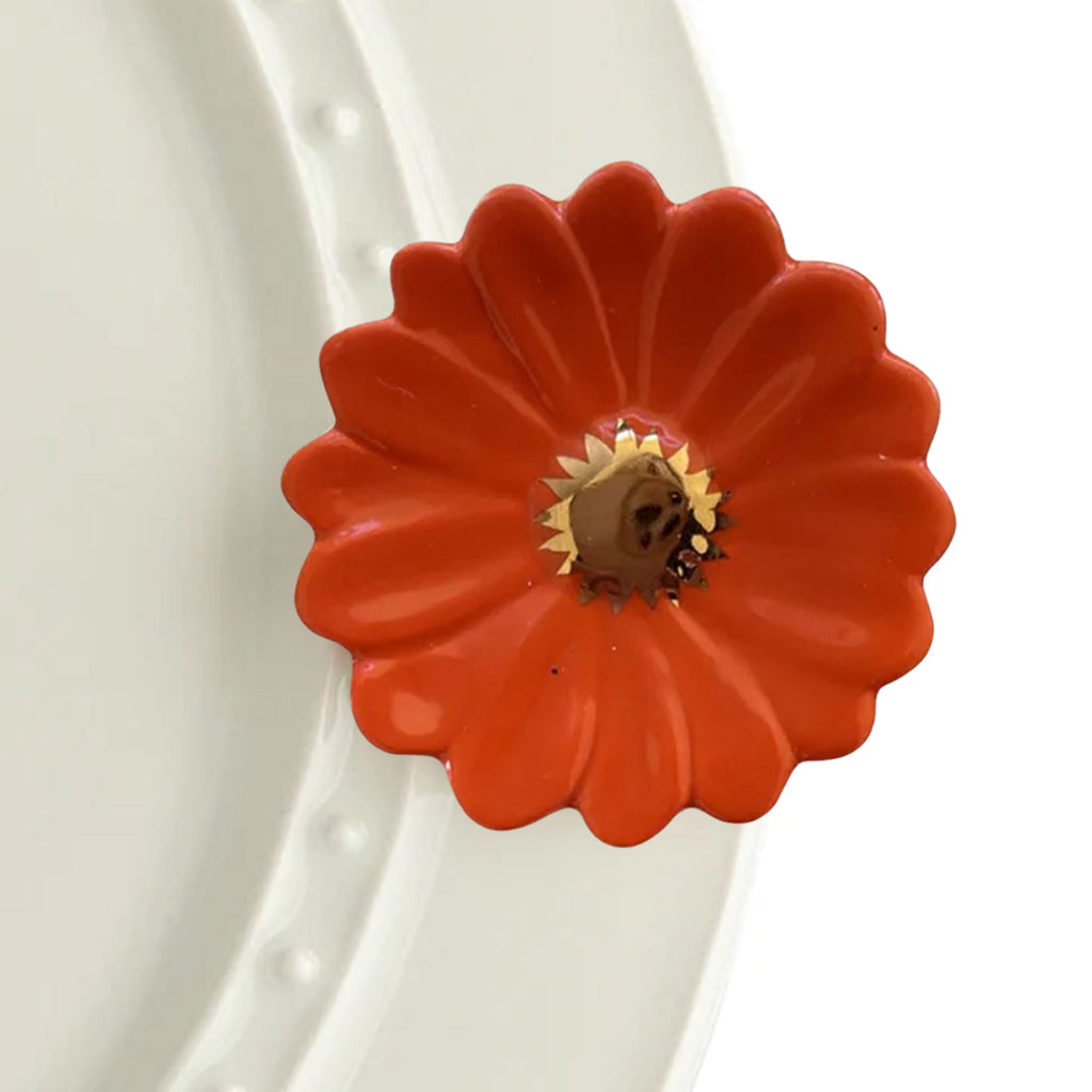 Nora Fleming Flower Power Orange on the plate