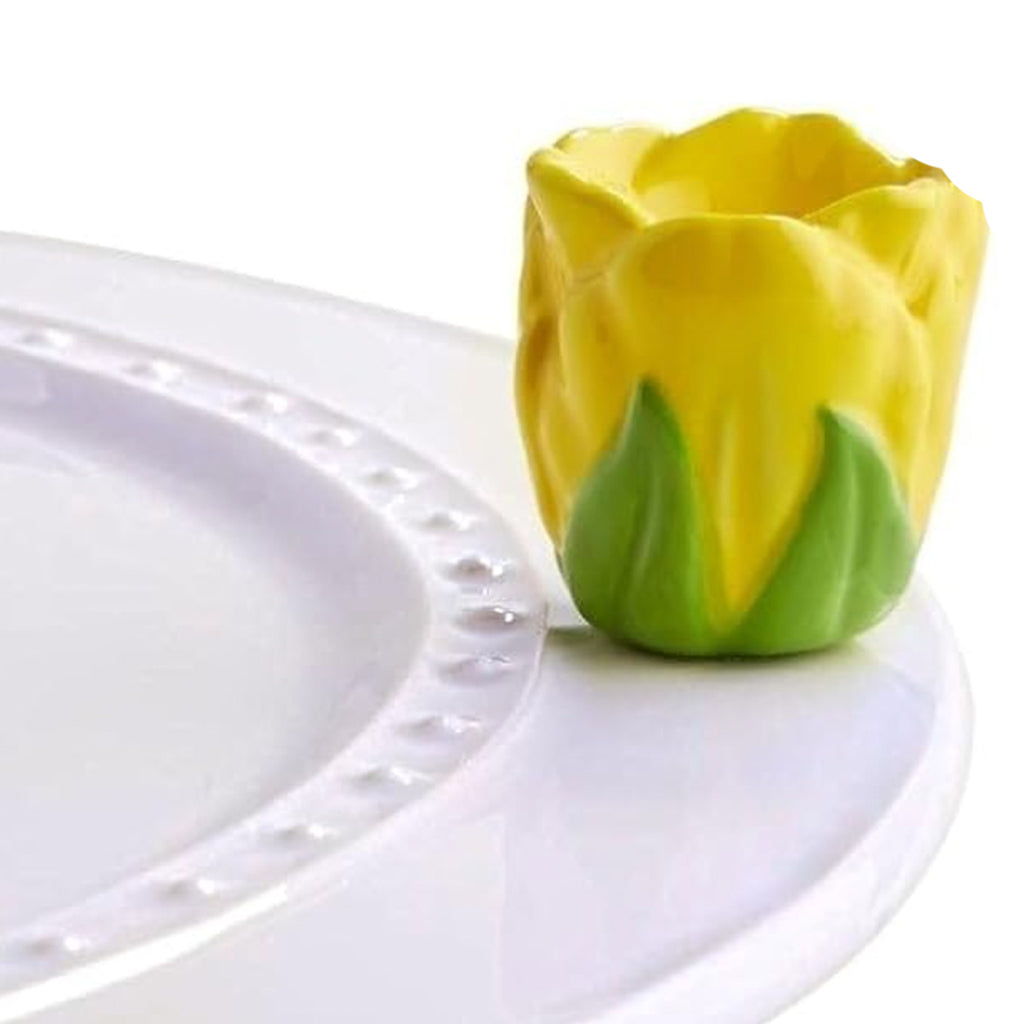 Nora Fleming Yellow Tulip Mini on the plate
