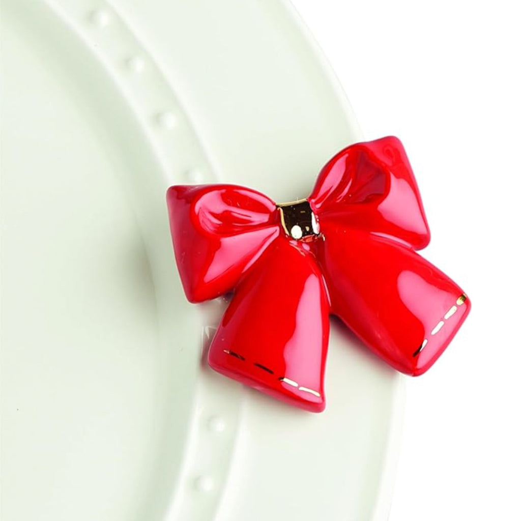 Nora Fleming Bow Mini on the plate