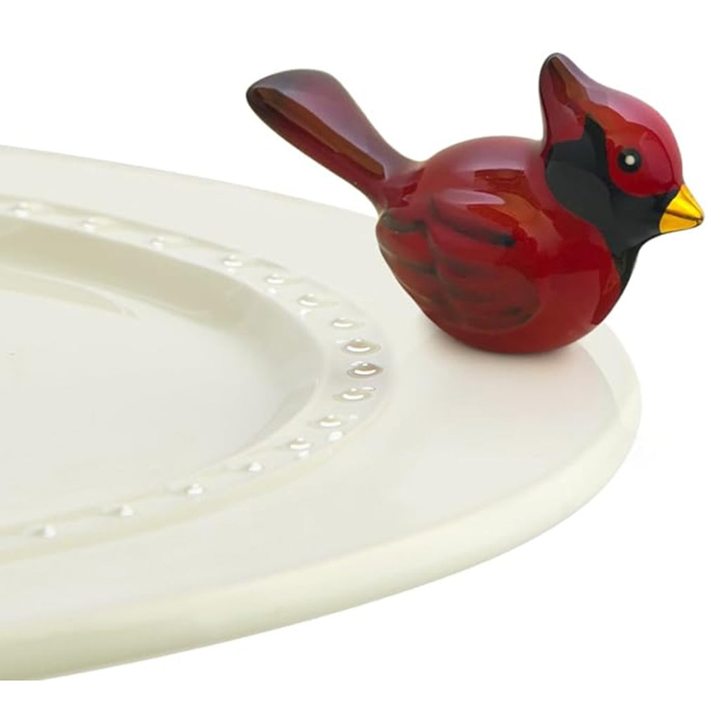 Nora Fleming Cardinal Mini on the plate