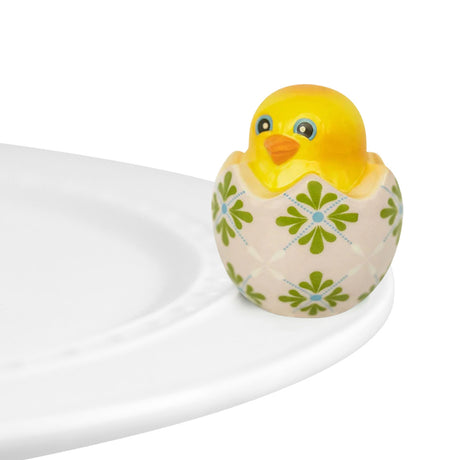 nora fleming chick in egg on the plate