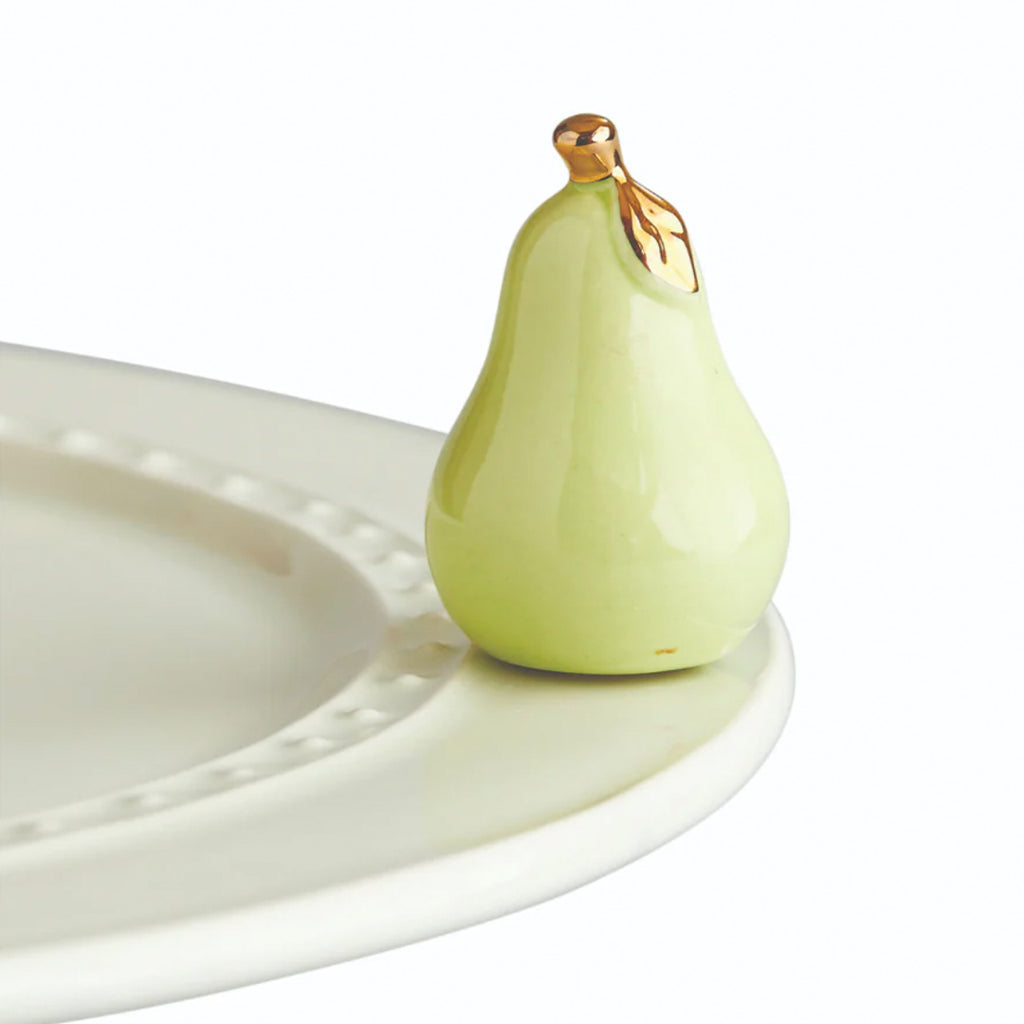 Nora Fleming Pear Mini on the plate