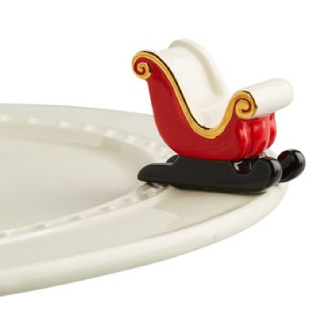 Nora fleming Sleigh Mini on the plate