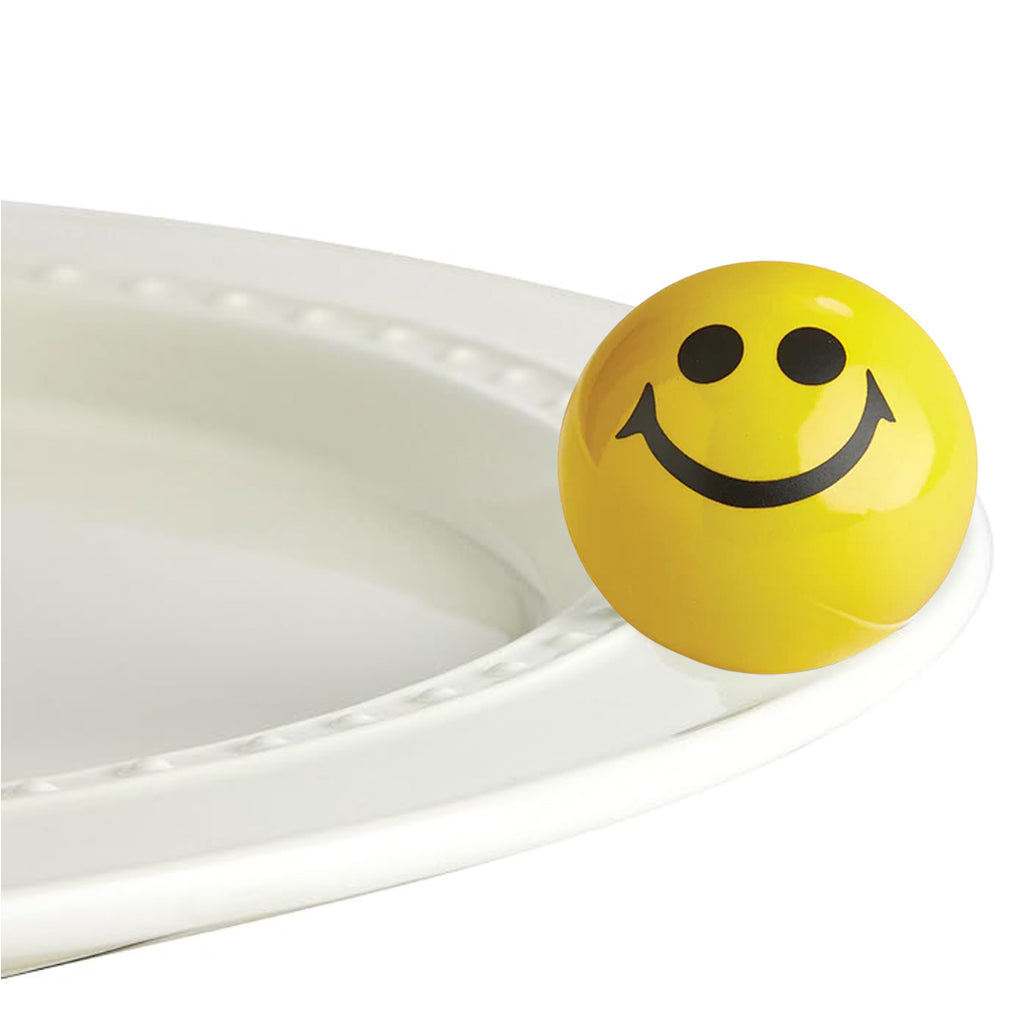 Nora Fleming Smile Face Mini on the plate