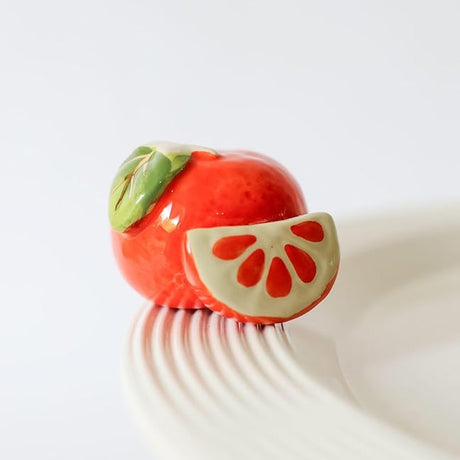 Nora Fleming cutie pie (clementine) on the plate